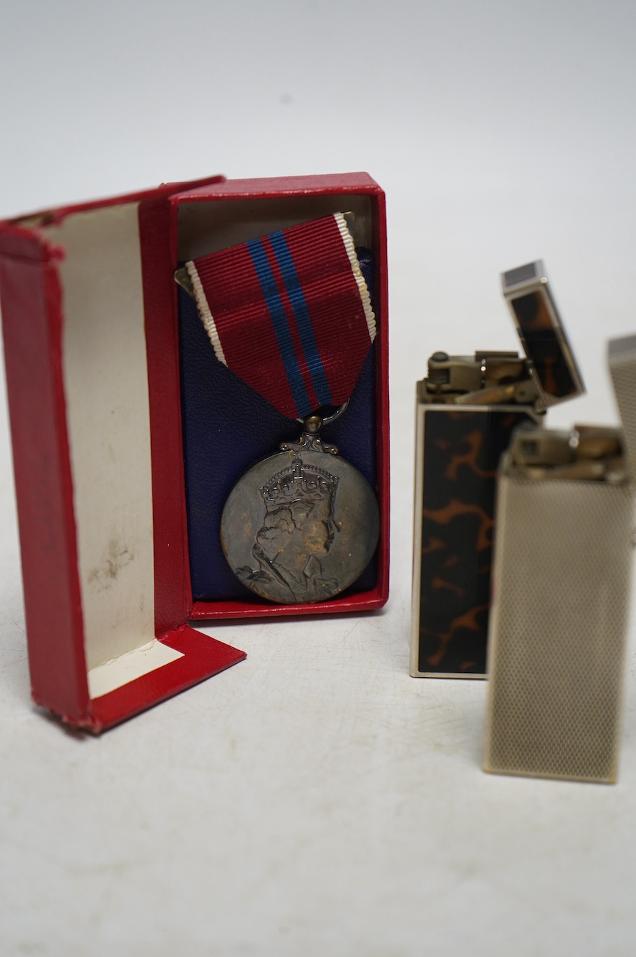 Two Dunhill lighters and a Coronation medal. Condition - some scratches